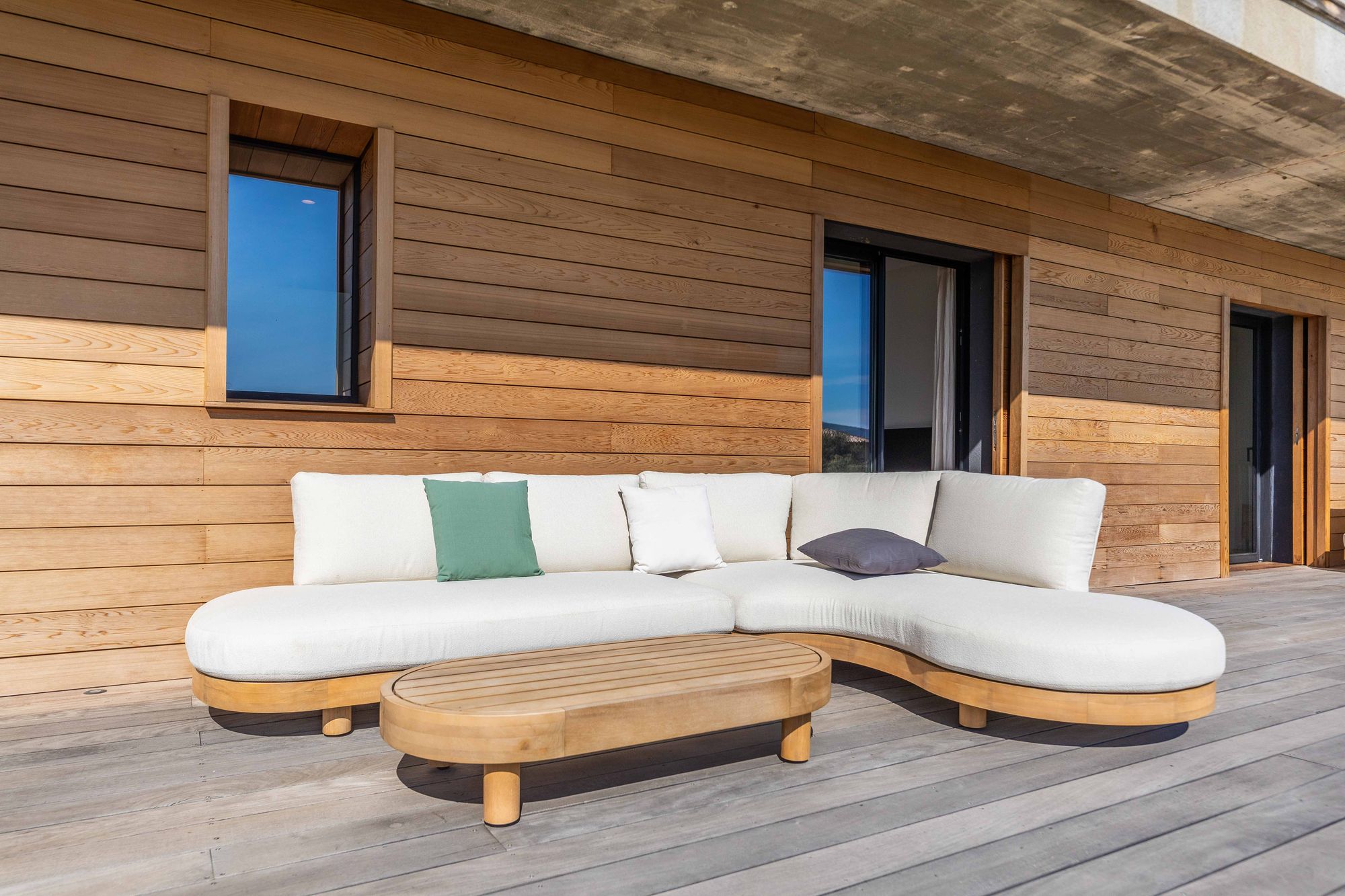 Cedar cladding detail with an outdoor sofa